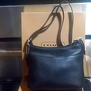 Vintage COACH black leather bag is NWT. Perfect condition in original box.